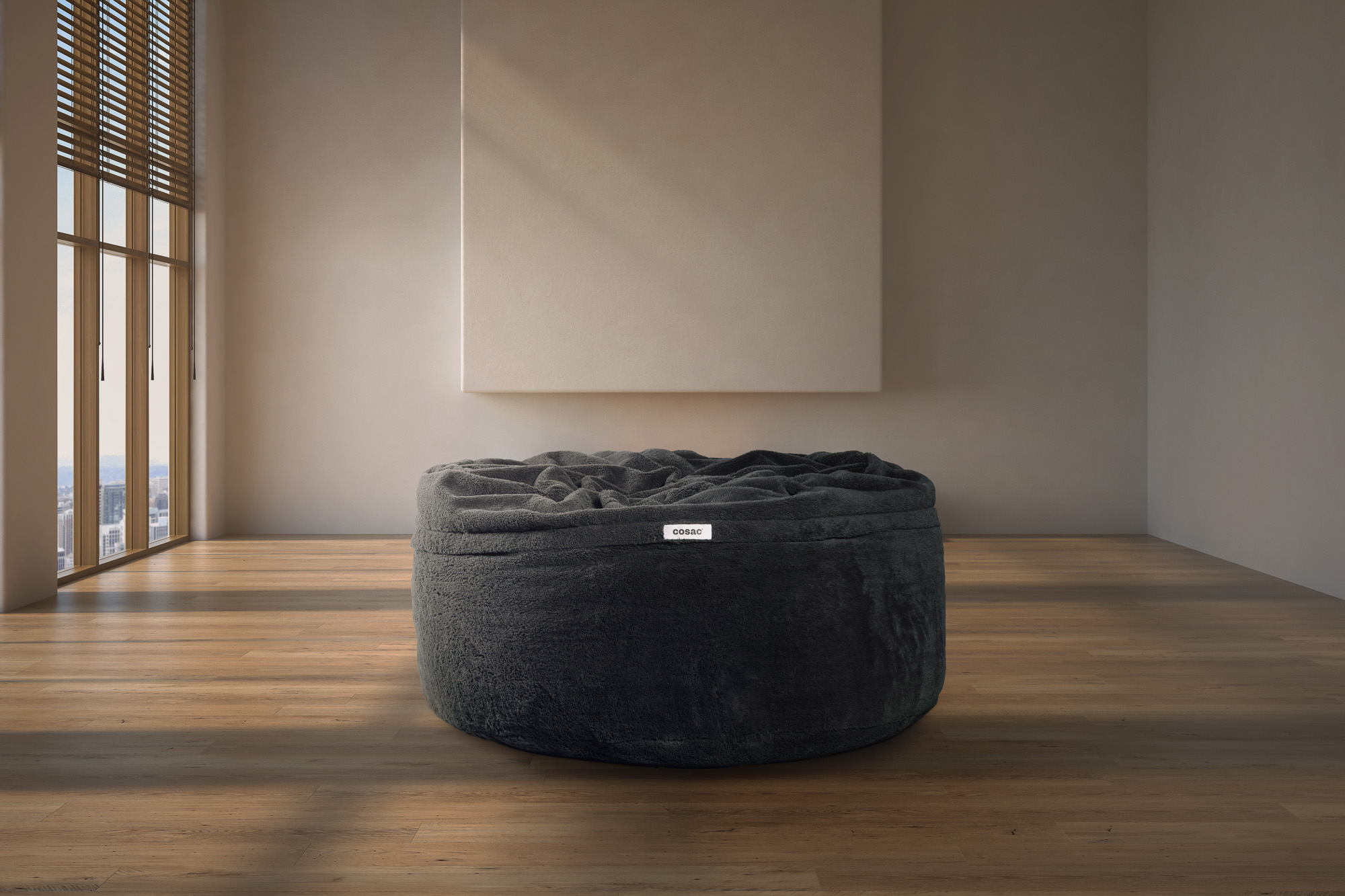 A 7ft charcoal Cosac beanbag positioned in front of a big screen TV ready for a couch co-op gaming session