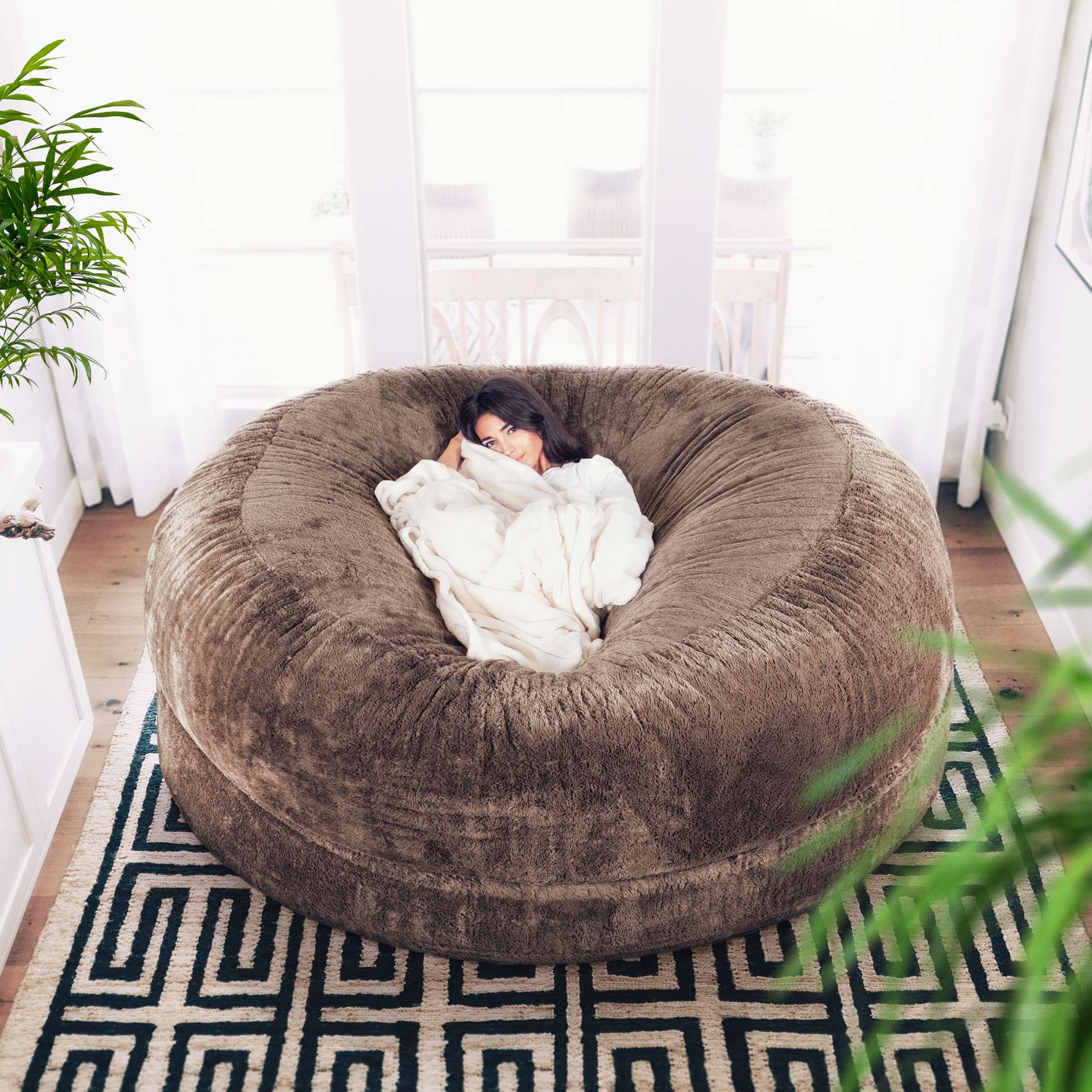 Woman lounging on The Cosac in Camel